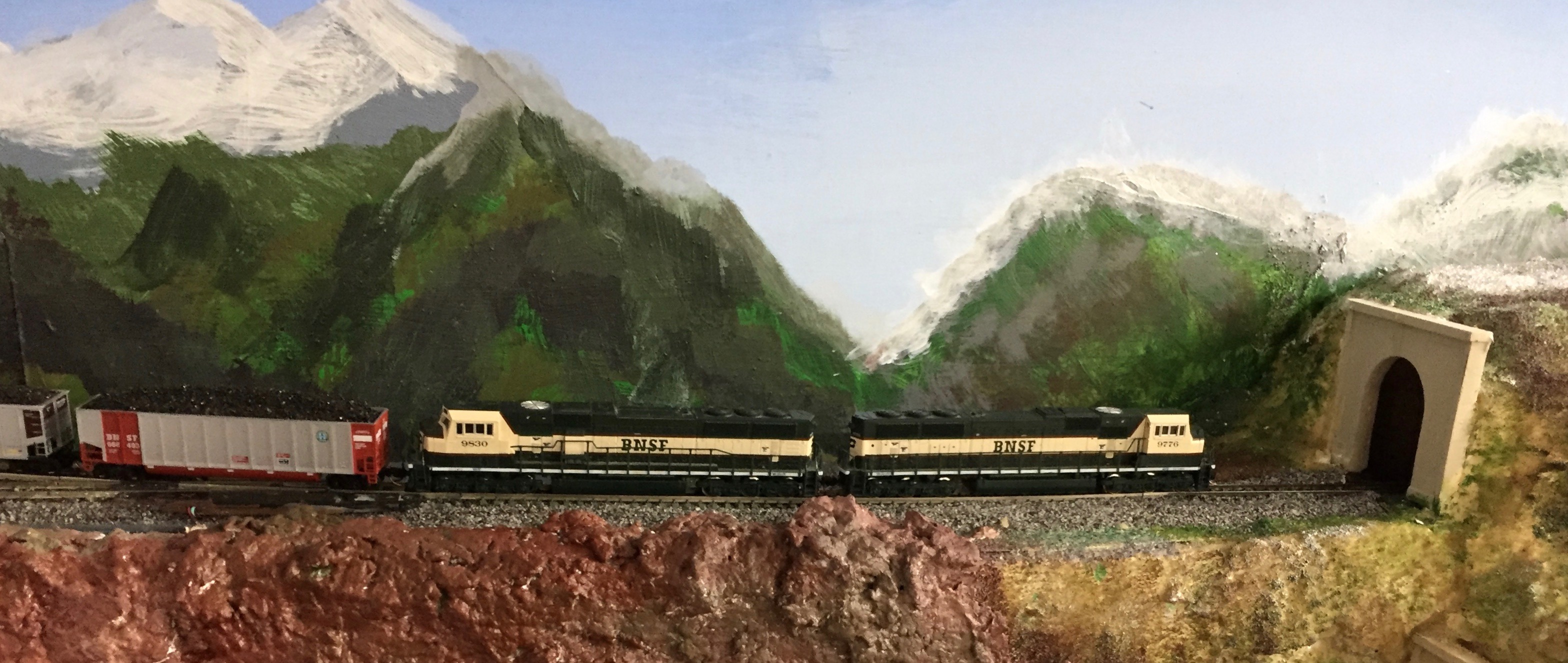 Two 70 MACs lead a unit coal train into a tunnel on the N Scale layout.
